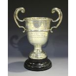 A George V silver trophy cup, the girdled 'U' shaped bowl flanked by two flying scroll handles and