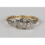 An 18ct gold and diamond three stone ring, mounted with a row of circular cut diamonds in a
