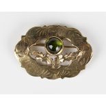 A gold and cabochon green tourmaline brooch of stylized thistle design, detailed '9ct', weight 5.1g,