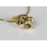 A gold, sapphire, diamond and ruby pendant, designed as a leopard's mask, detailed '14K', weight 3.