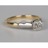 An 18ct gold, platinum and diamond single stone ring, claw set with a circular cut diamond, detailed