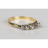 A gold and diamond five stone ring, claw set with a row of cushion cut diamonds, detailed '18ct',