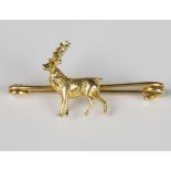 A gold bar brooch with a standing stag motif, detailed '9c', weight 4.1g, width 4cm.Buyer’s