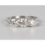 A platinum and diamond three stone ring, claw set with three circular cut diamonds, detailed 'Plat',