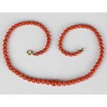 A single row necklace of graduated coral beads on a 9ct gold boltring clasp, length 40cm, and a pair