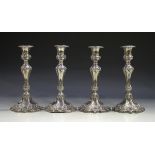A set of four early Victorian silver candlesticks, each with a detachable nozzle and urn shaped