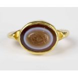 A gold and oval banded agate intaglio ring, possibly Roman or of Roman design, the intaglio carved