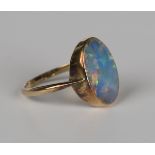 A gold and opal single stone ring, collet set with an oval opal doublet, detailed '9ct', weight 2.