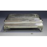 A Peruvian .925 silver rectangular cigarette box, the hinged lid engraved with foliate scrolls, on