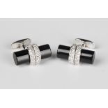 A pair of white gold, diamond and black onyx dress cufflinks, each with an oval black onyx baton,