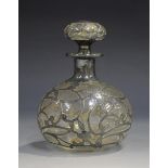 An early 20th century sterling silver overlaid clear glass globular scent bottle and stopper,