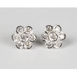 A pair of white gold and diamond floral cluster earrings, each collet set with seven circular cut