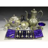 A collection of plated items, including a pair of candlesticks, two teapots and a tankard.Buyer’s