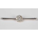 A platinum fronted, gold and diamond bar brooch, the centre with a principal circular cut diamond