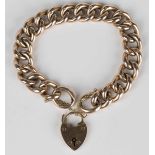 A gold hollow curb link bracelet, detailed '9c', on a 9ct gold heart shaped padlock clasp,