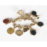 A 9ct gold oval link charm bracelet, fitted with ten pendants and charms, including four agate set