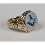 A 15ct gold and sardonyx Masonic ring, carved with a square and compass between scroll sides,