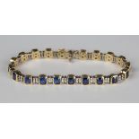 An 18ct gold, sapphire and diamond bracelet, mounted with canted corner rectangular cut sapphires
