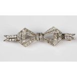 A diamond brooch in a tied ribbon bow design, mounted with circular cut and rose cut diamonds, width