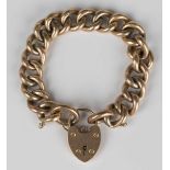 A gold hollow curb link bracelet, detailed '9c', on a 9ct gold heart shaped padlock clasp,