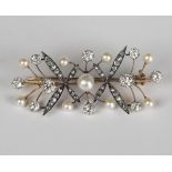 A gold backed and silver set, diamond and cultured pearl brooch in a twin spray design, mounted with