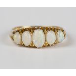 An Edwardian 18ct gold and opal five stone ring, mounted with a row of graduated oval opals, Chester