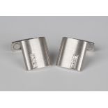 A pair of white gold and diamond dress cufflinks, each with a curved rectangular front with a