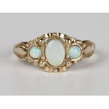 A 9ct gold ring, mounted with an oval opal between two circular opals, London 1991, weight 3.1g,