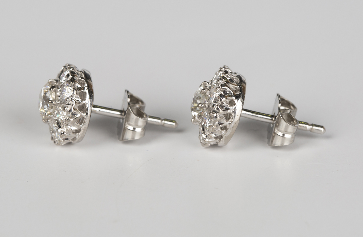 A pair of diamond cluster earrings, each claw set with the principal circular cut diamond within a - Image 4 of 4