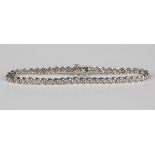 A 9ct white gold and diamond bracelet, mounted with a row of circular cut diamonds, on a snap clasp,