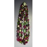 A Hattie Carnegie three row graduated necklace of vari-coloured plastic and glass beads on a