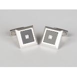 A pair of white gold, black onyx and diamond dress cufflinks, each square front mounted with a