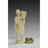 A Japanese carved ivory okimono netsuke, 19th century, modelled as a Buddhistic lion with left paw