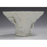 A Chinese blanc-de-Chine porcelain libation cup, probably Kangxi period, of traditional horn form,