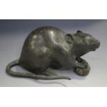 A Japanese brown patinated bronze figure of a rat, Meiji period, modelled clasping a nut,