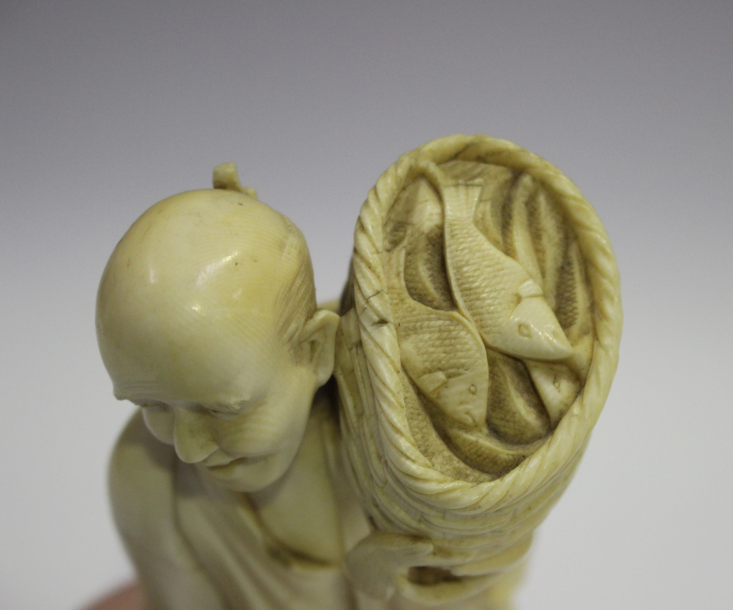 A Japanese carved ivory okimono netsuke, 19th century, modelled as a Buddhistic lion with left paw - Image 4 of 8