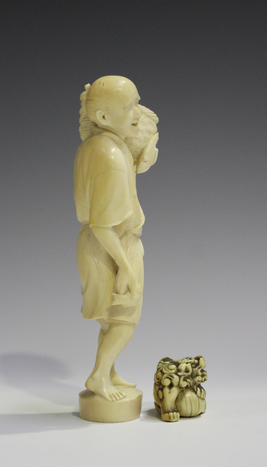 A Japanese carved ivory okimono netsuke, 19th century, modelled as a Buddhistic lion with left paw - Image 6 of 8