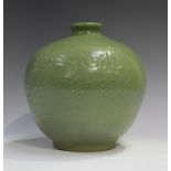 A Chinese celadon glazed vase, Ming style but probably Qing dynasty, of stout ovoid form, carved