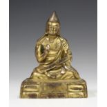 A Sino-Tibetan gilt bronze figure of a lama, probably late Qing/20th century, modelled seated