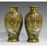 A pair of Japanese Satsuma earthenware vases, Meiji period, each ribbed ovoid body painted and