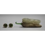 A Chinese jade snuff bottle, 20th century, carved in the form of a mouse lying upon a corn cob,