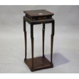 A Chinese hardwood stand, early 20th century, the square panelled top above a shaped scroll apron,