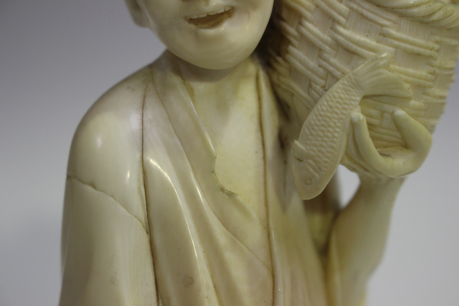 A Japanese carved ivory okimono netsuke, 19th century, modelled as a Buddhistic lion with left paw - Image 3 of 8