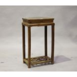 A Chinese elm stand, late Qing dynasty, the rectangular panelled top above a scroll carved frieze,