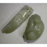 A Chinese pale celadon jade pendant, probably late Qing dynasty or later, carved as two cats, length