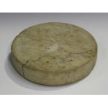 An Islamic stone idol of circular tablet form with shallow groove across the centre of each side,