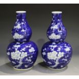 A pair of Chinese blue and white porcelain gourd vases, mark of Kangxi but modern, each painted with