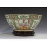 A Chinese Canton famille rose porcelain punch bowl, late 19th century, typically painted with panels