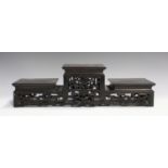 A Chinese hardwood three-tier stand, late Qing dynasty, of rectangular form, the raised central