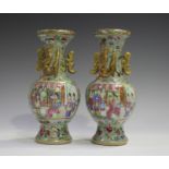 A pair of Chinese Canton famille rose enamelled celadon ground porcelain vases, mid to late 19th